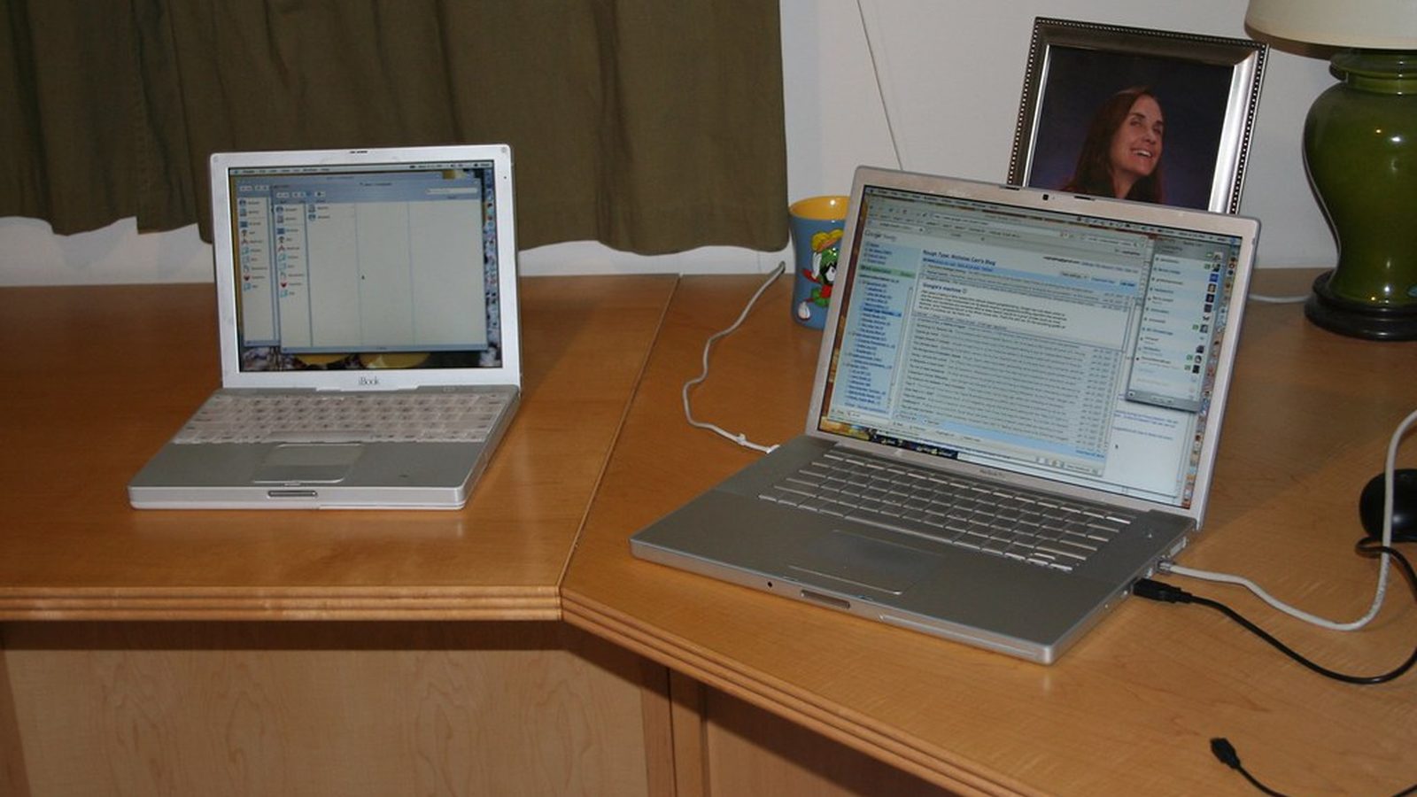 Printed email screenshots stacked on an editor's desk with grading marks and a green pencil